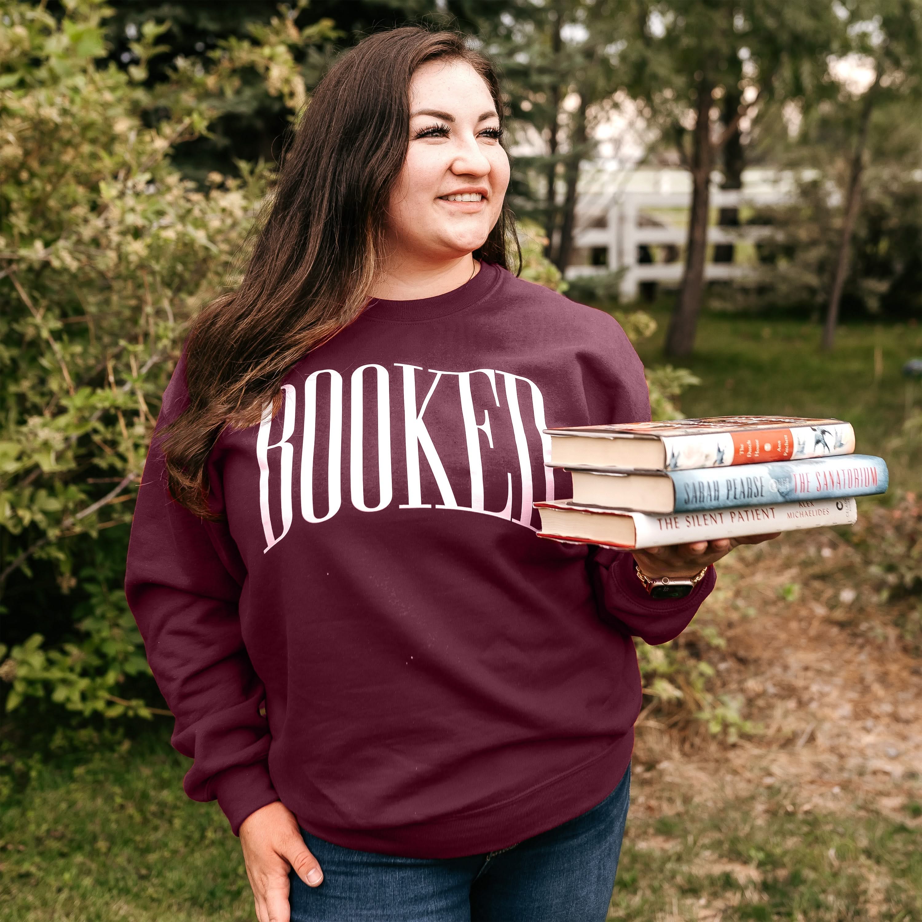 Basic fleece in maroon with 'BOOKED' graphic on chest, shown on model – Little Mama Shirt Shop