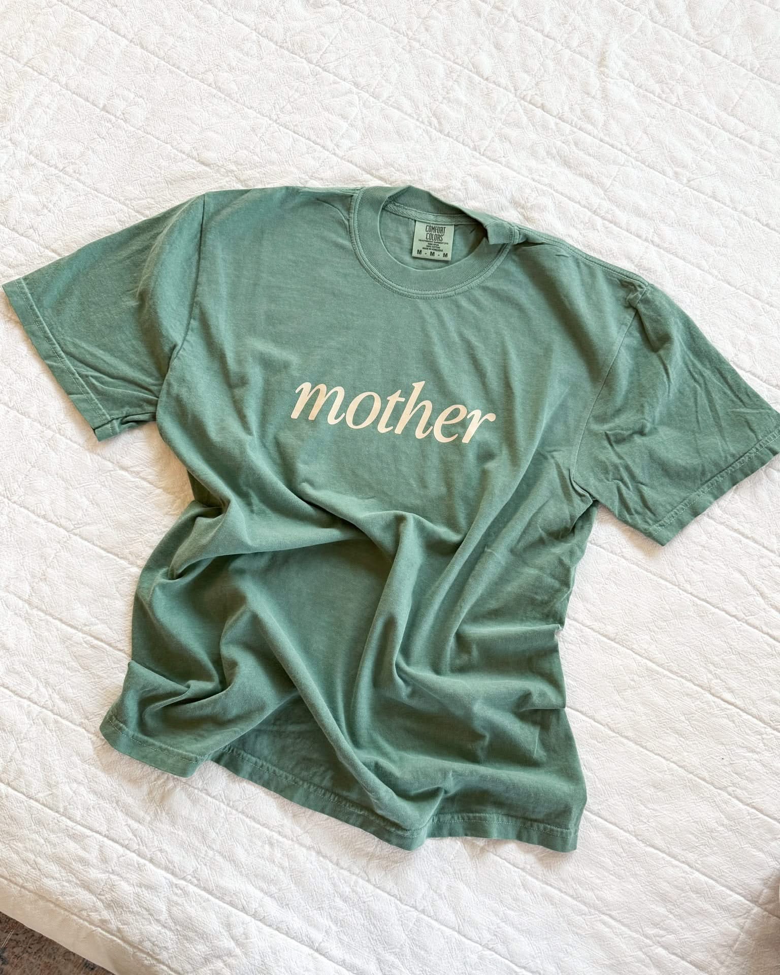 Adult tee in alpine with 'mother' printed on the front, seen on flat lay - Little Mama Shirt Shop